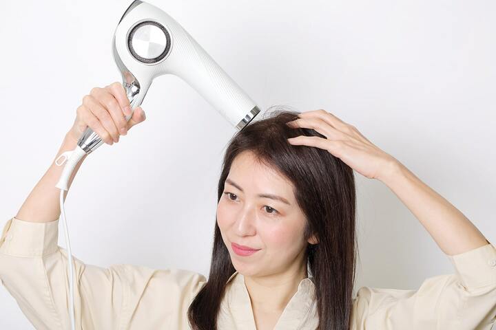 トップが真ん中でぱっくり分かれないように、ドライヤーの風をサイドから根元に当て、トップが立ち上がるように乾かす。
